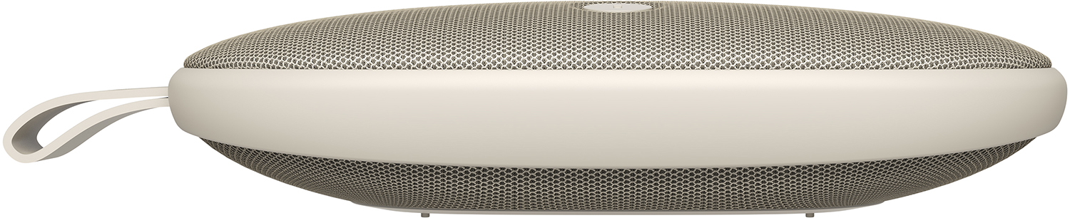 Cream colored speaker with a loop. White background, side view.