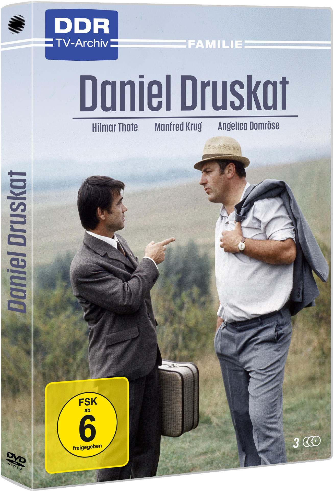 DVD-Hülle für Daniel Druskat: Zwei Männer in Anzügen unterhalten sich auf einem Feld. Mit FSK 6 Aufkleber.