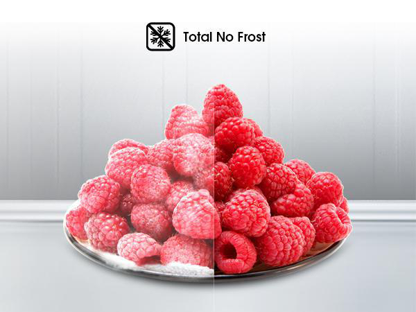 Ein Teller Himbeeren, einige gefroren, einige frisch. Die Worte 'Total No Frost' erscheinen oben.
