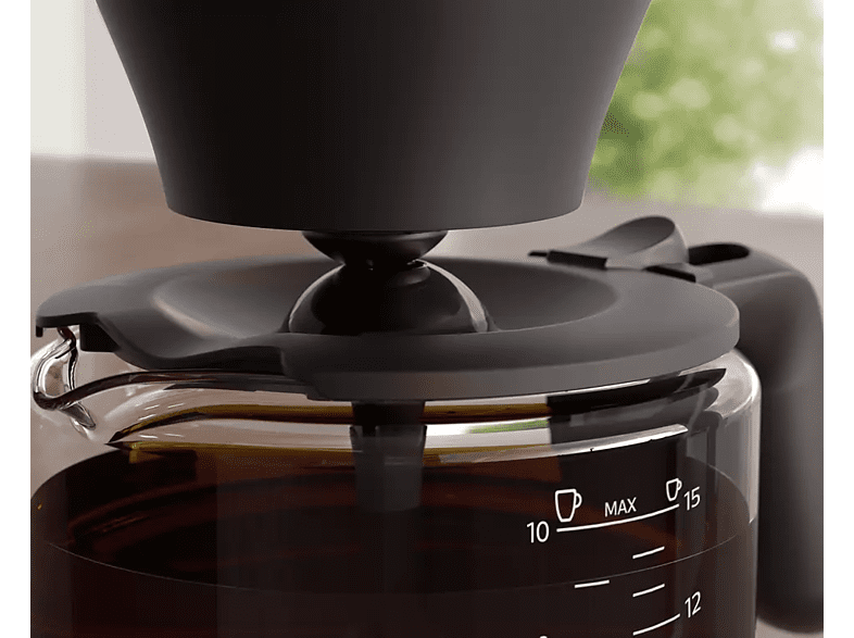 Close-up of coffee maker. Coffee is brewing into a glass carafe.