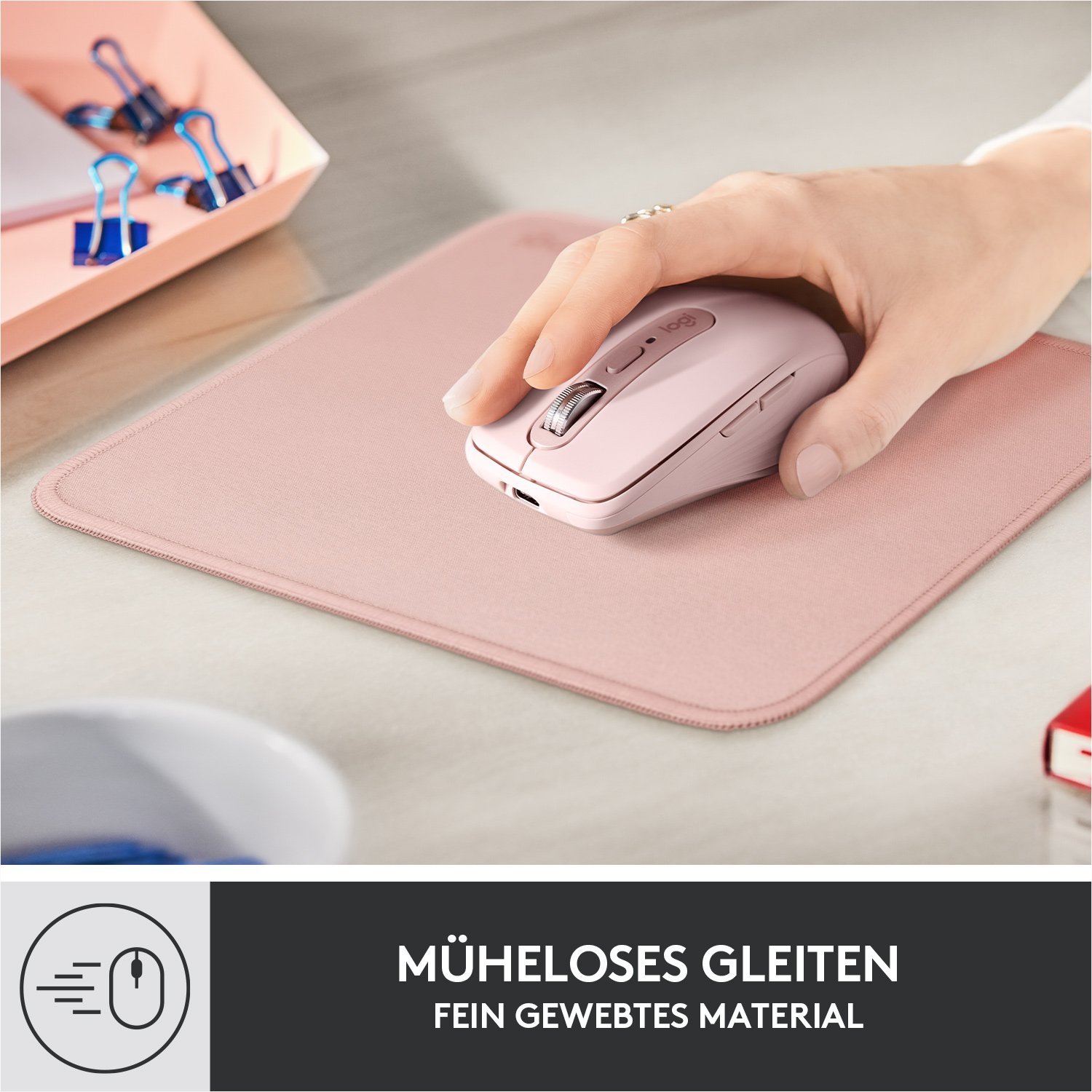 Hand einer Frau, die eine rosa Maus auf einem rosa Mauspad benutzt. Weißer Tisch.