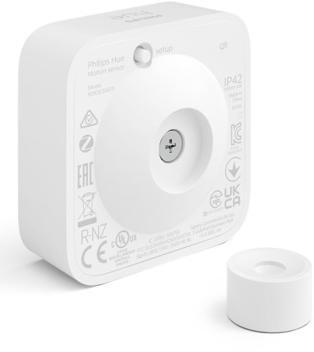 White square Philips Hue motion sensor. A small round base is next to it.