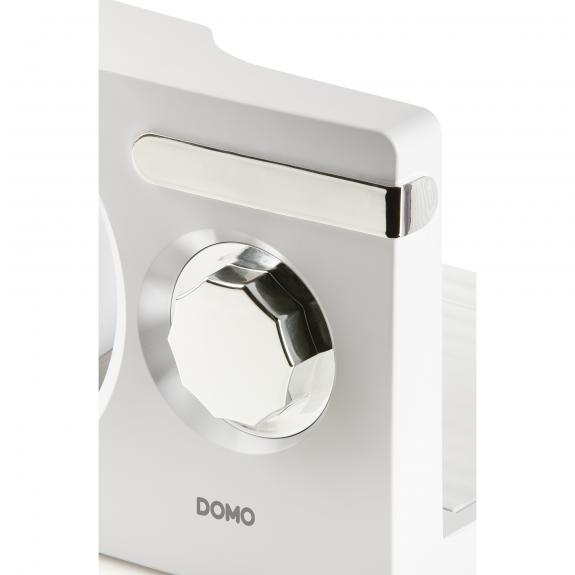 Close-up of a white kitchen appliance with a silver dial and the DOMO logo.