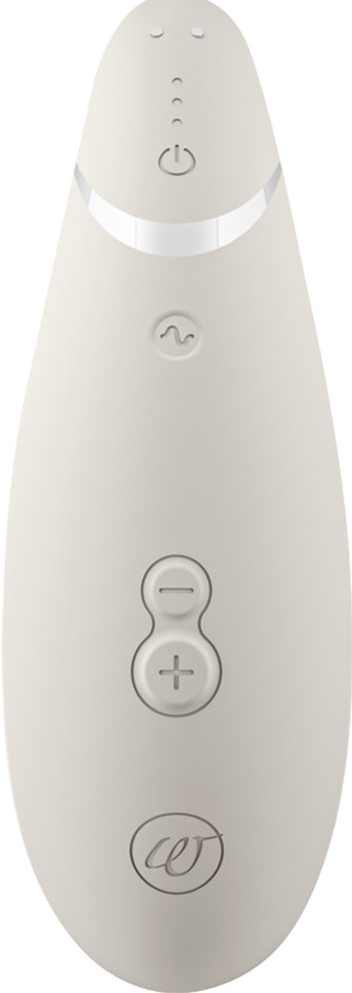 Un appareil de beauté beige avec des boutons, dont marche/arrêt, onde et commandes plus/moins.