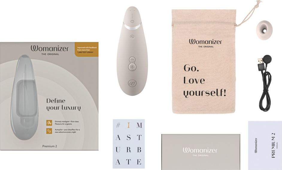 Ensemble de produits Womanizer : appareil, sac, accessoires et emballage.