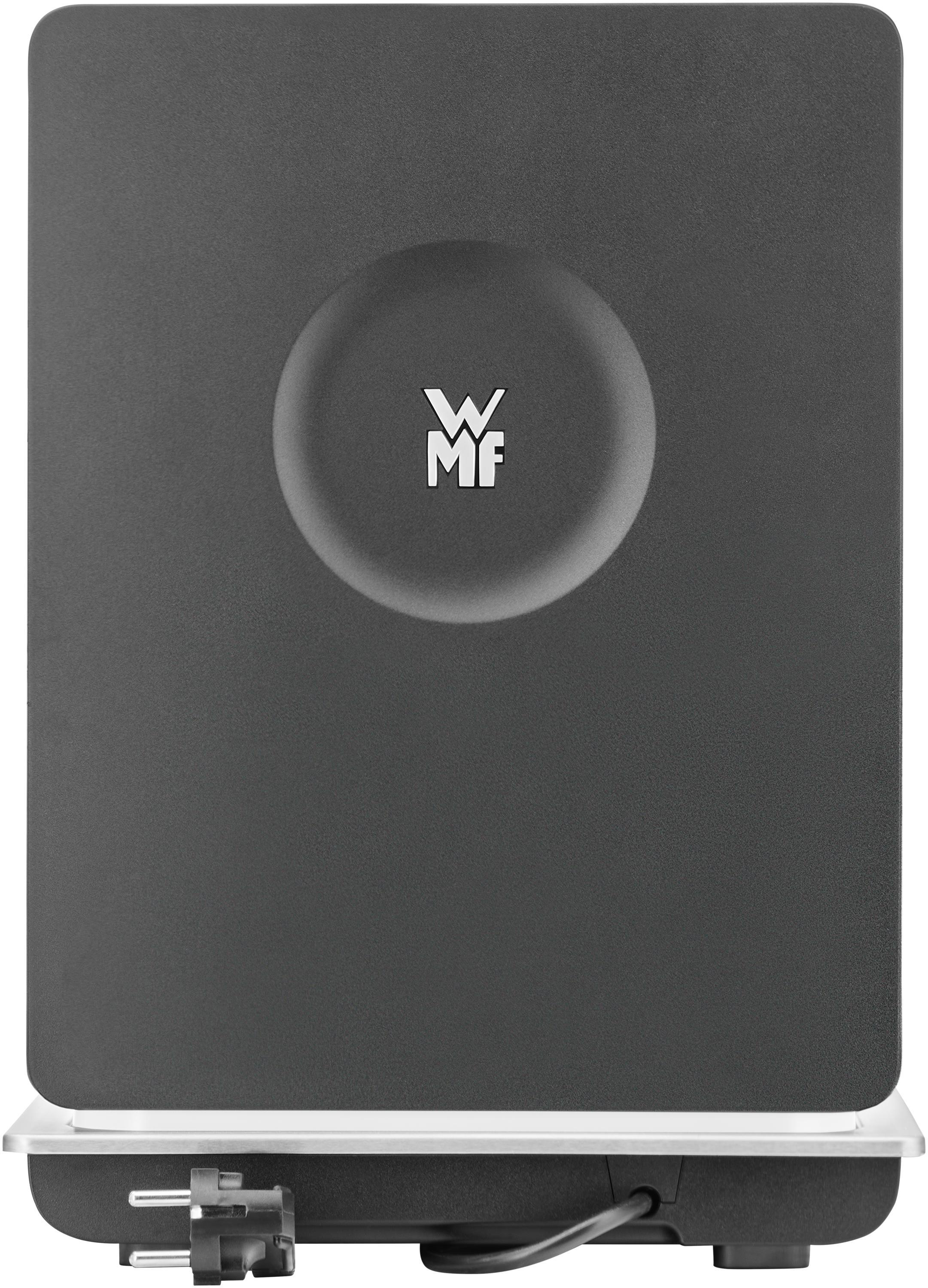 Schwarze Oberfläche mit WMF-Logo, kreisförmiger Vertiefung und Netzstecker.