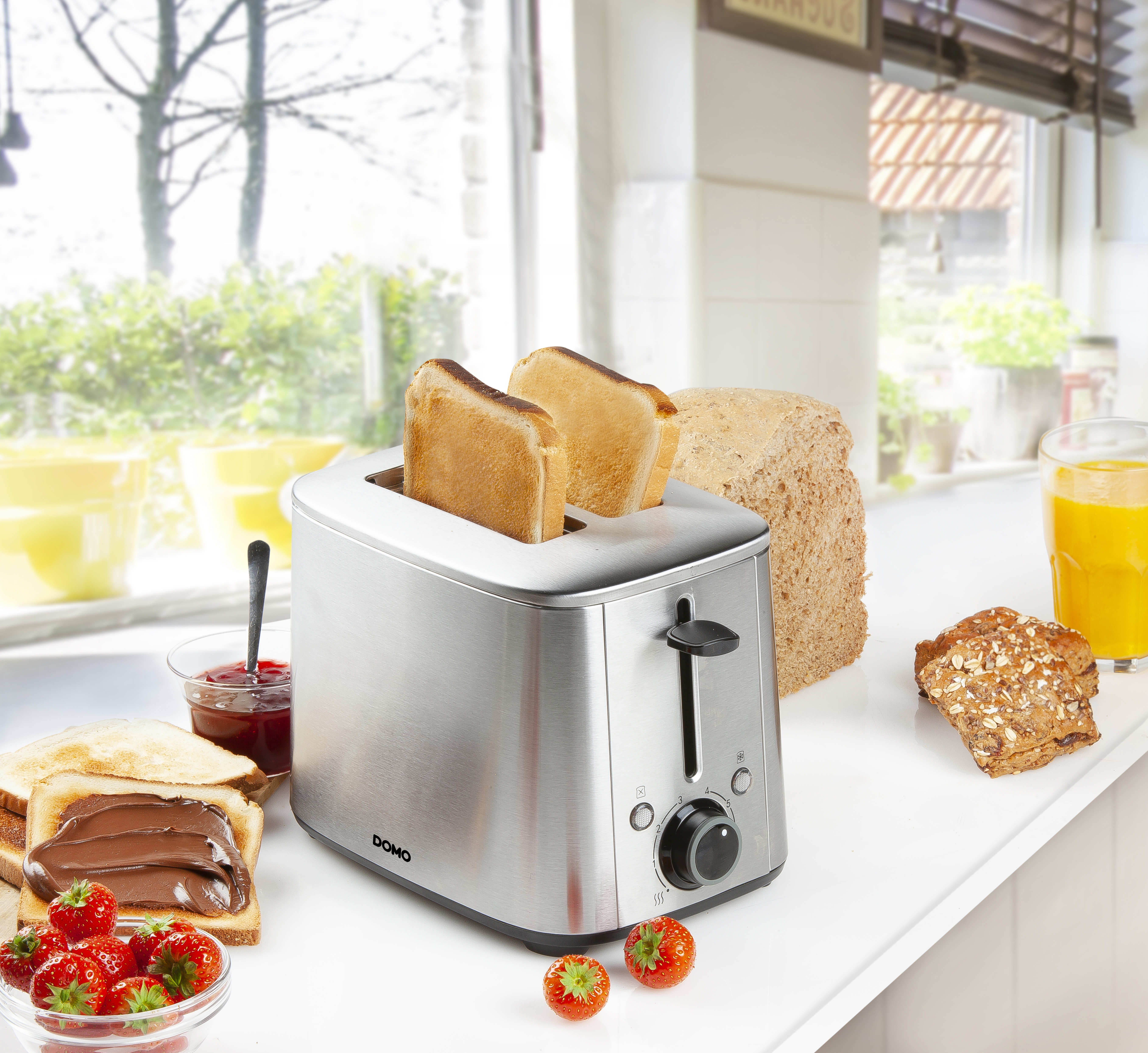 A toaster with toasted bread, a jar of jam, and a slice of bread with chocolate spread.