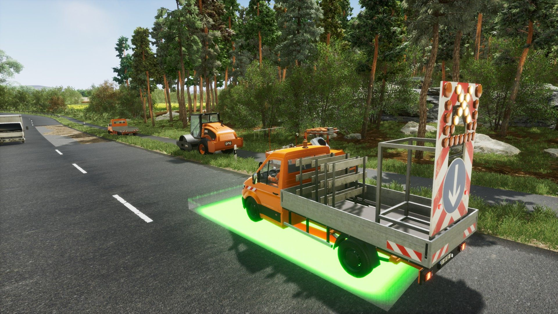 Una scena stradale con veicoli per la costruzione stradale e un camion con segnali.