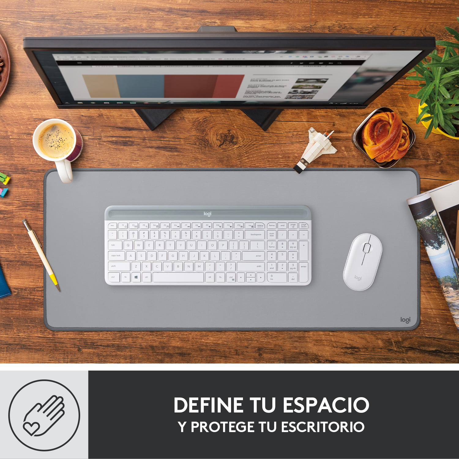 Espacio de trabajo con teclado, ratón, monitor y una taza de café.