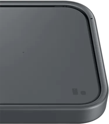 Dark gray wireless charging pad with a slightly raised edge. Small camera lens on the top.