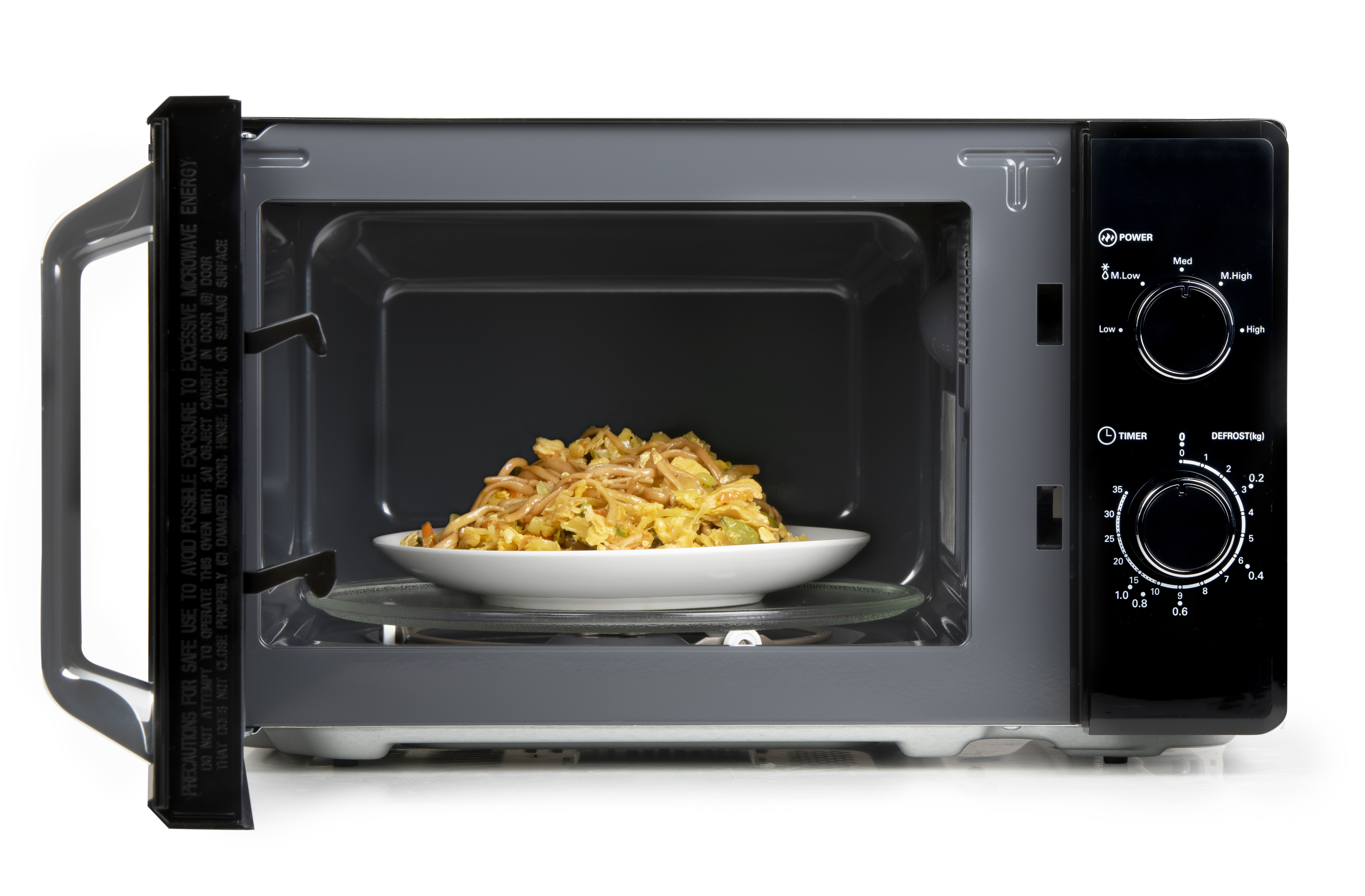 A plate of noodles is inside a microwave that is open.