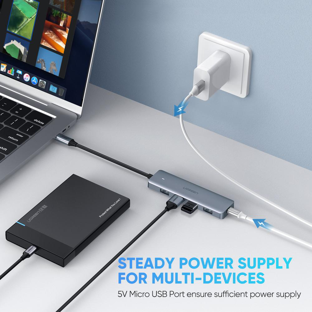 Un ordinateur portable connecté à un hub USB avec plusieurs appareils branchés.