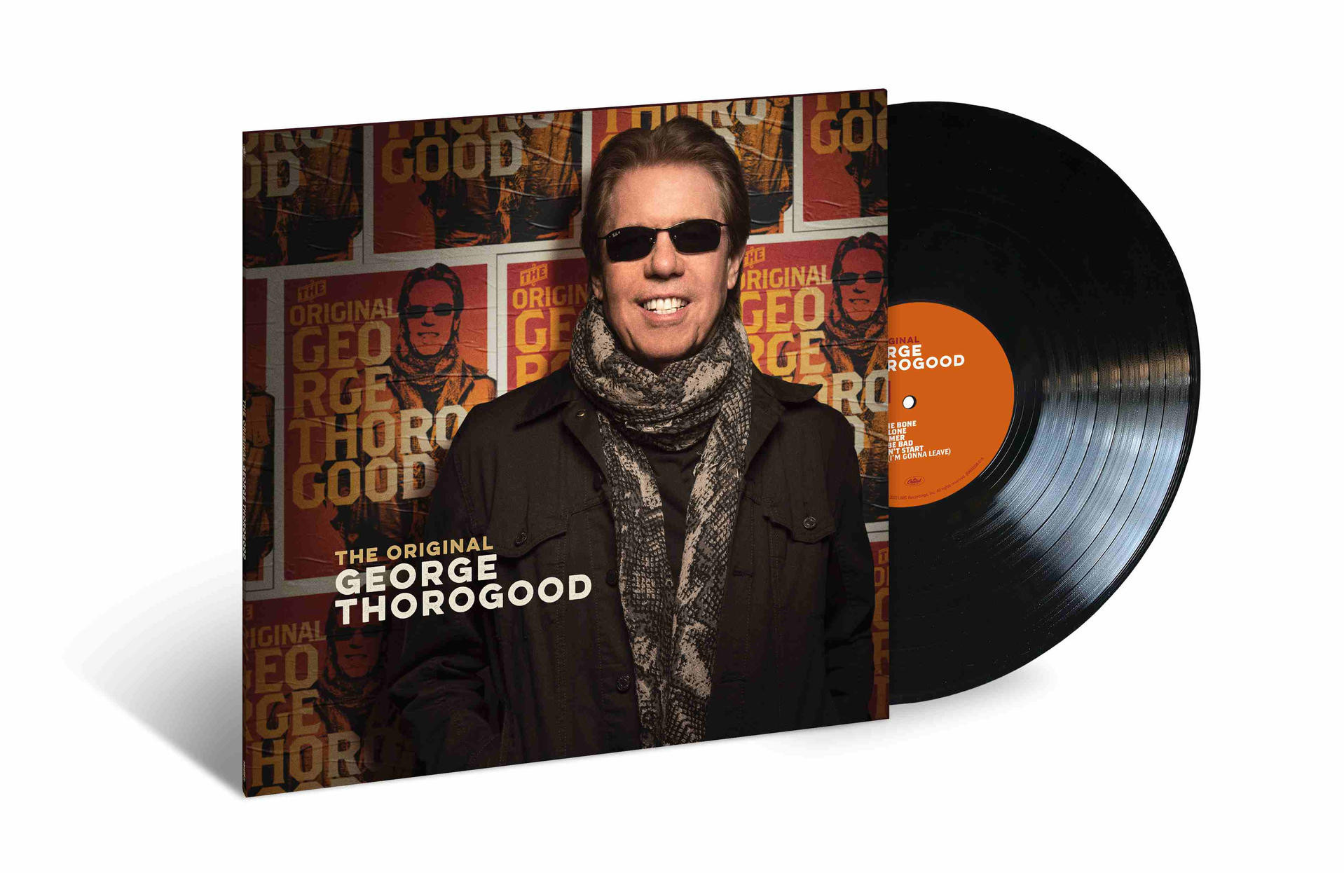 George Thorogood Albumcover. Thorogood mit Sonnenbrille, schwarzer Jacke und Schal, mit Vinyl.