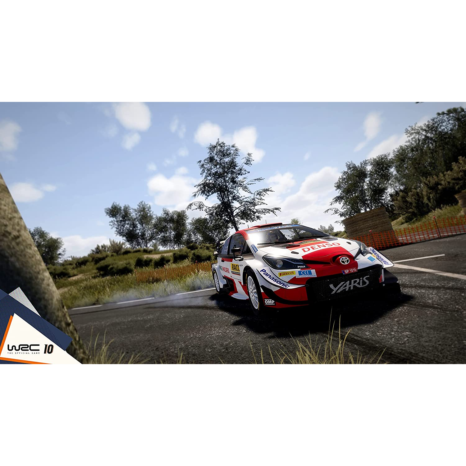 Un coche de rally WRC 10 corriendo en un camino de tierra con árboles y cielo.