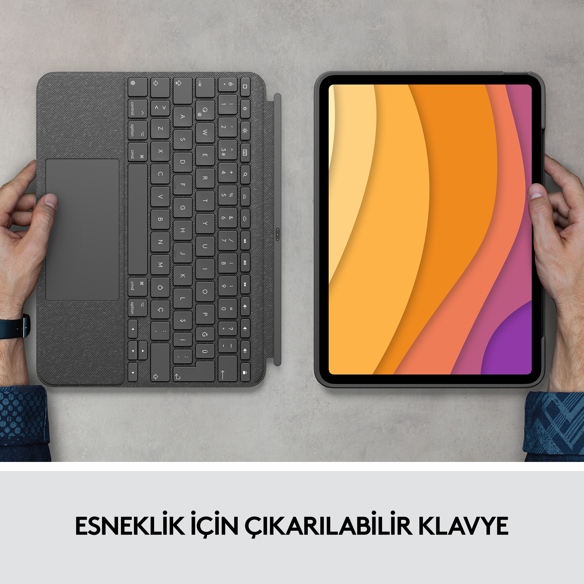 Eller bir tablet ve bir klavye kılıfı tutuyor. Tablet, renkli soyut bir tasarım gösteriyor.