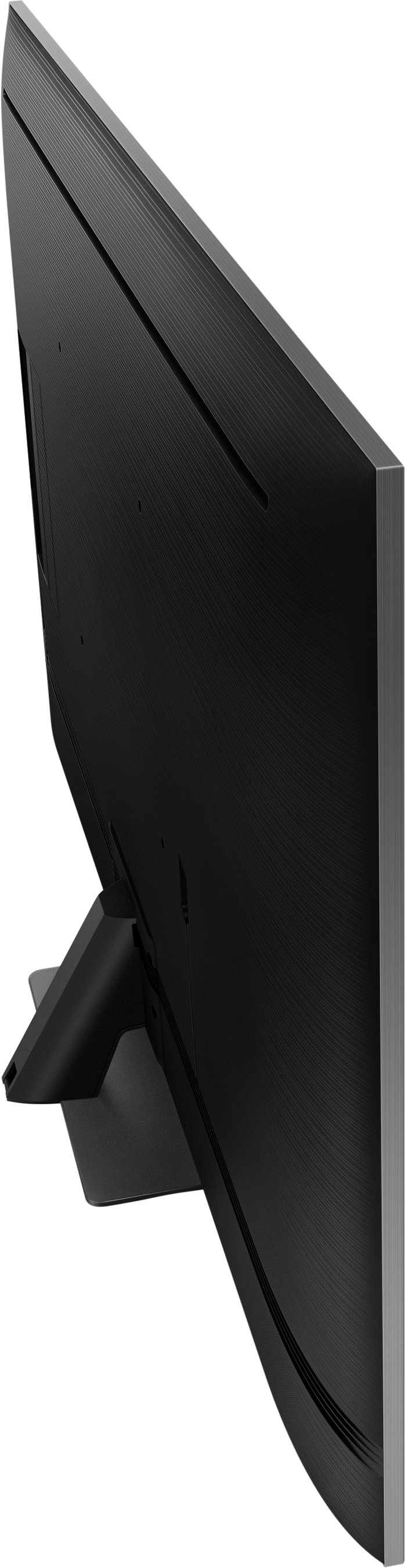Une vue latérale d'une télévision noire avec un pied. L'écran est sombre. L'arrière-plan est noir.