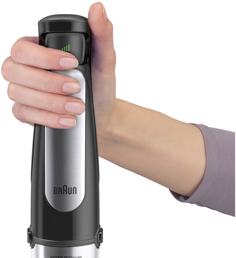 A woman's hand holding a black and silver Braun ActiveBlade immersion blender.