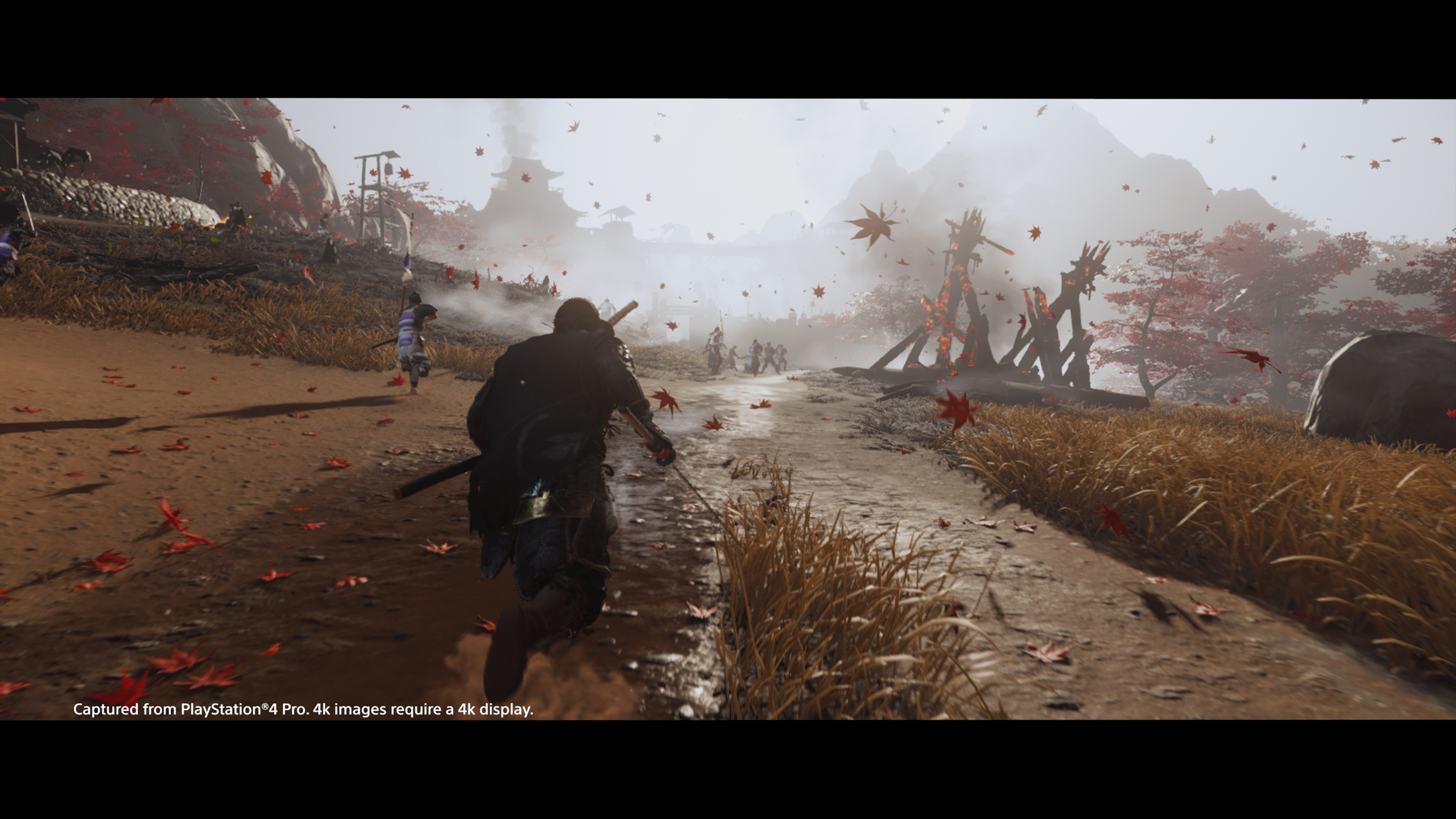 A game scene with a character running through a field with enemies and falling leaves.