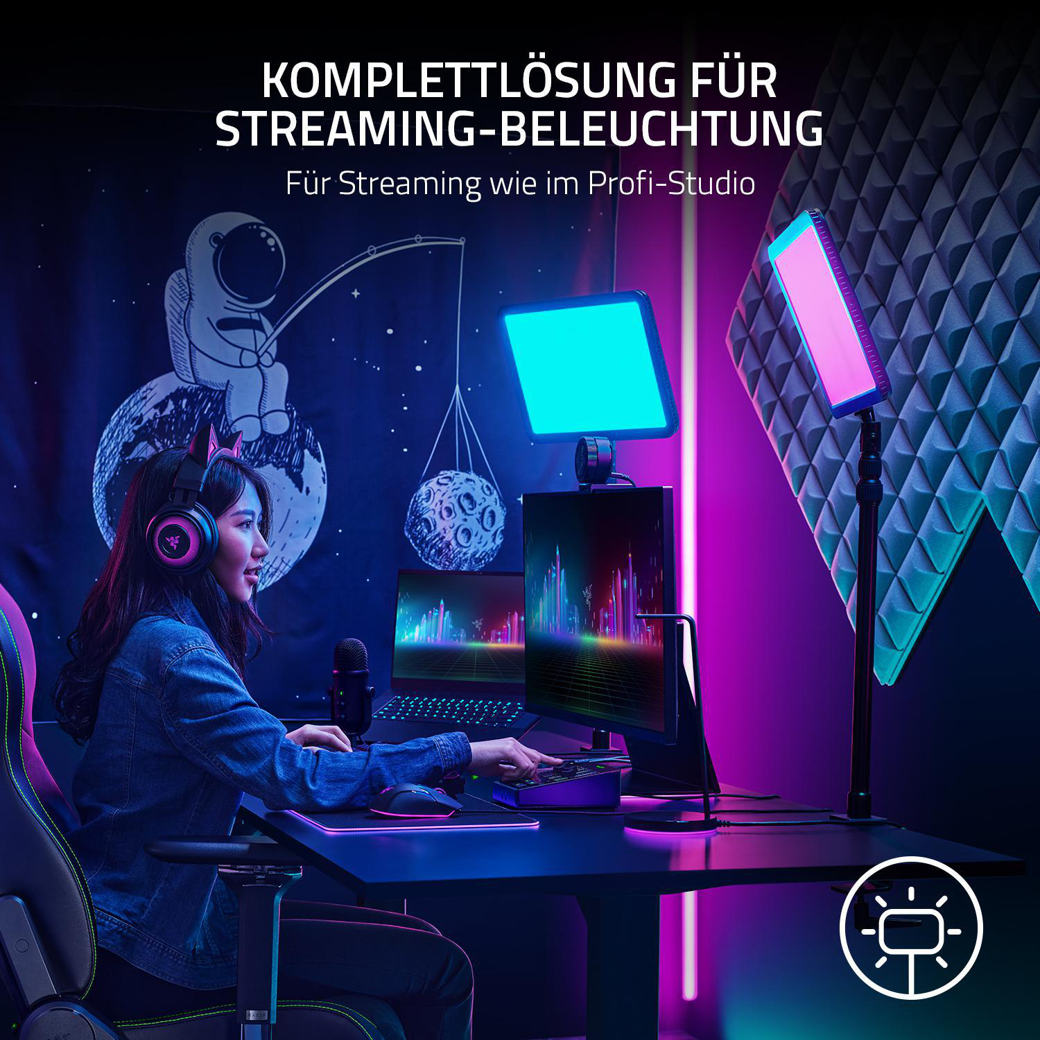 Eine Frau streamt mit Lichtern, Kopfhörern und einem Computer.