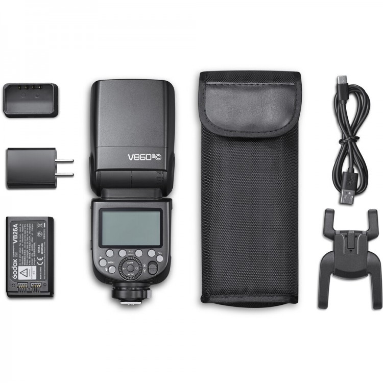 Ein Godox V860III III Blitzgerät-Kit auf weißem Hintergrund mit Zubehör.