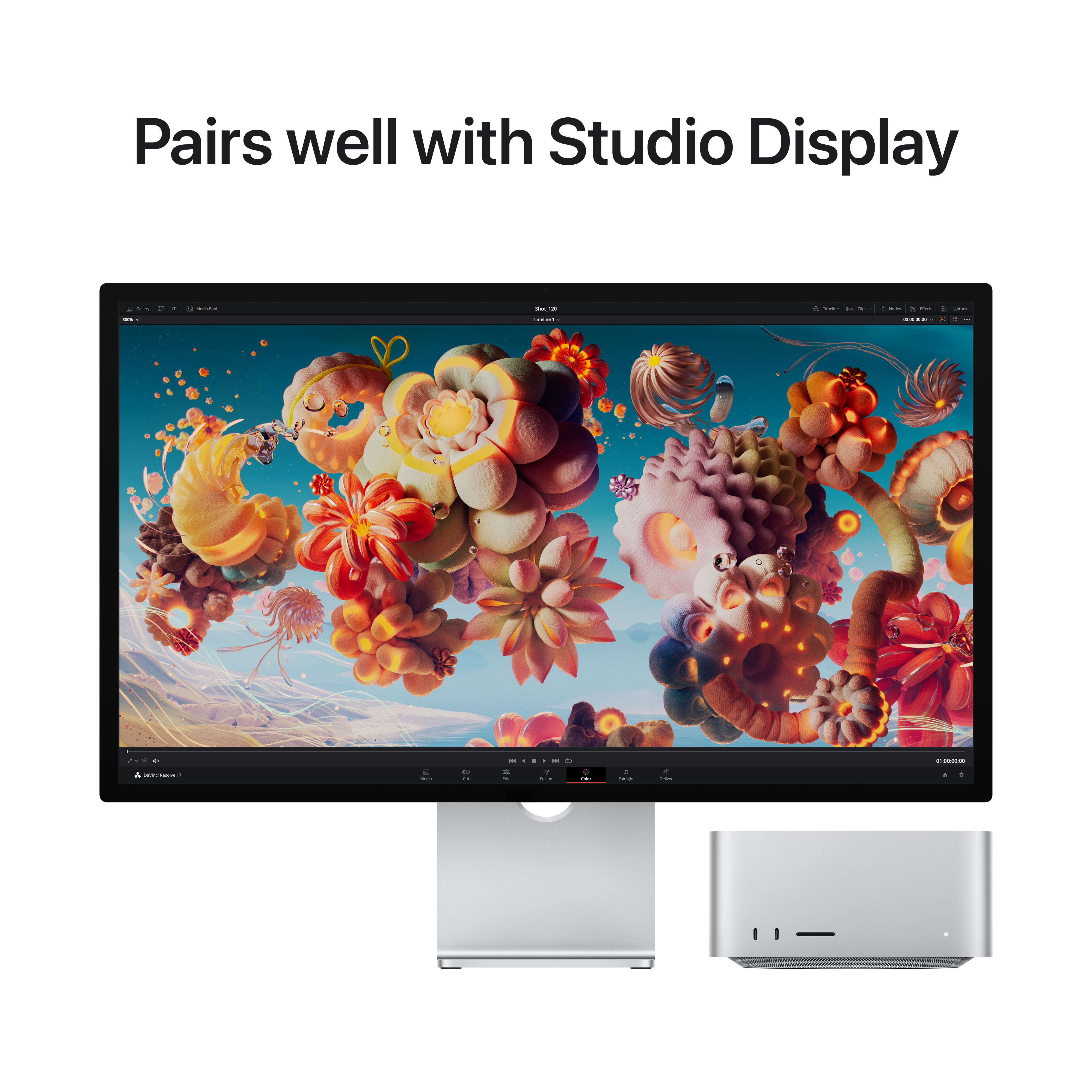 Een computerscherm met kleurrijke kunst en twee zilveren computertorens, met studio-weergavetekst.