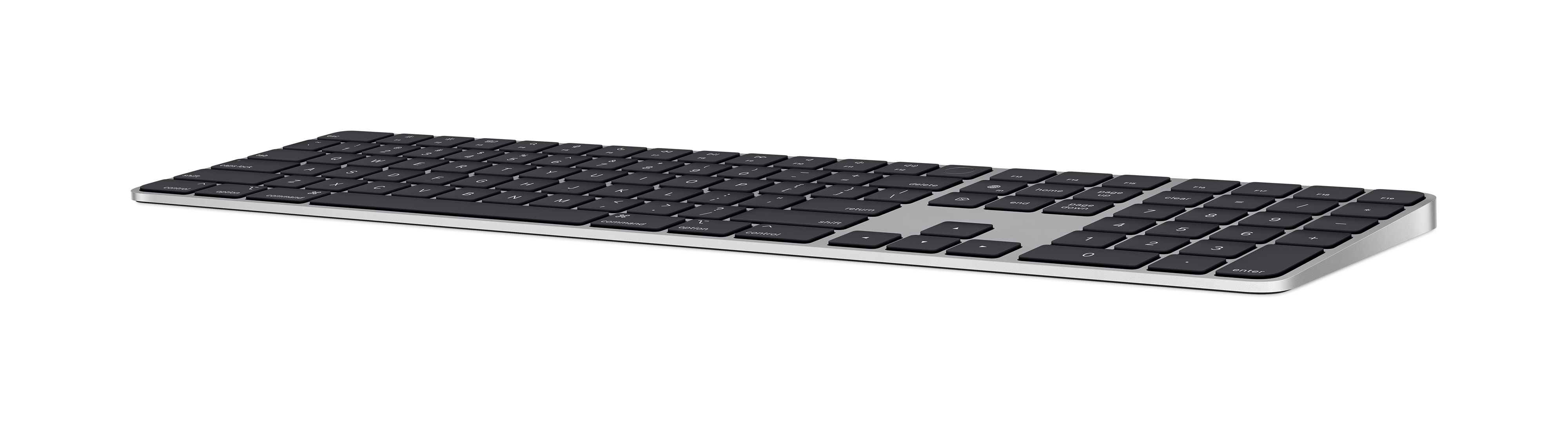 A black Apple keyboard with black keys and a silver base on a black background.