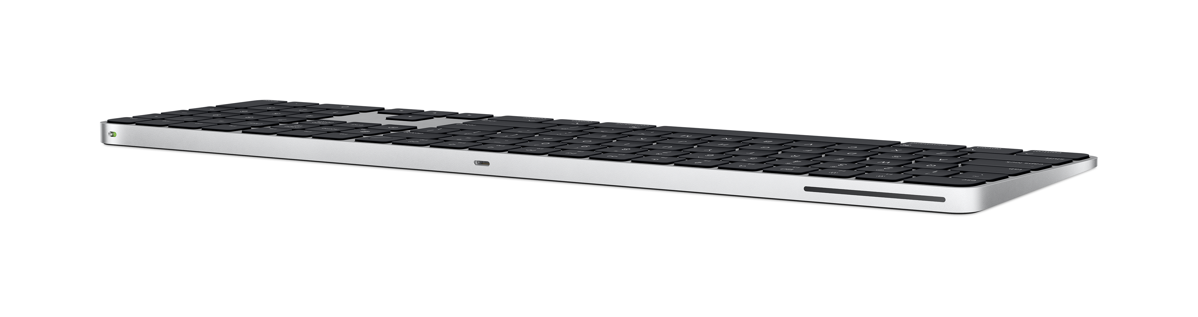 Silver keyboard on a black background. The keyboard is long and thin.