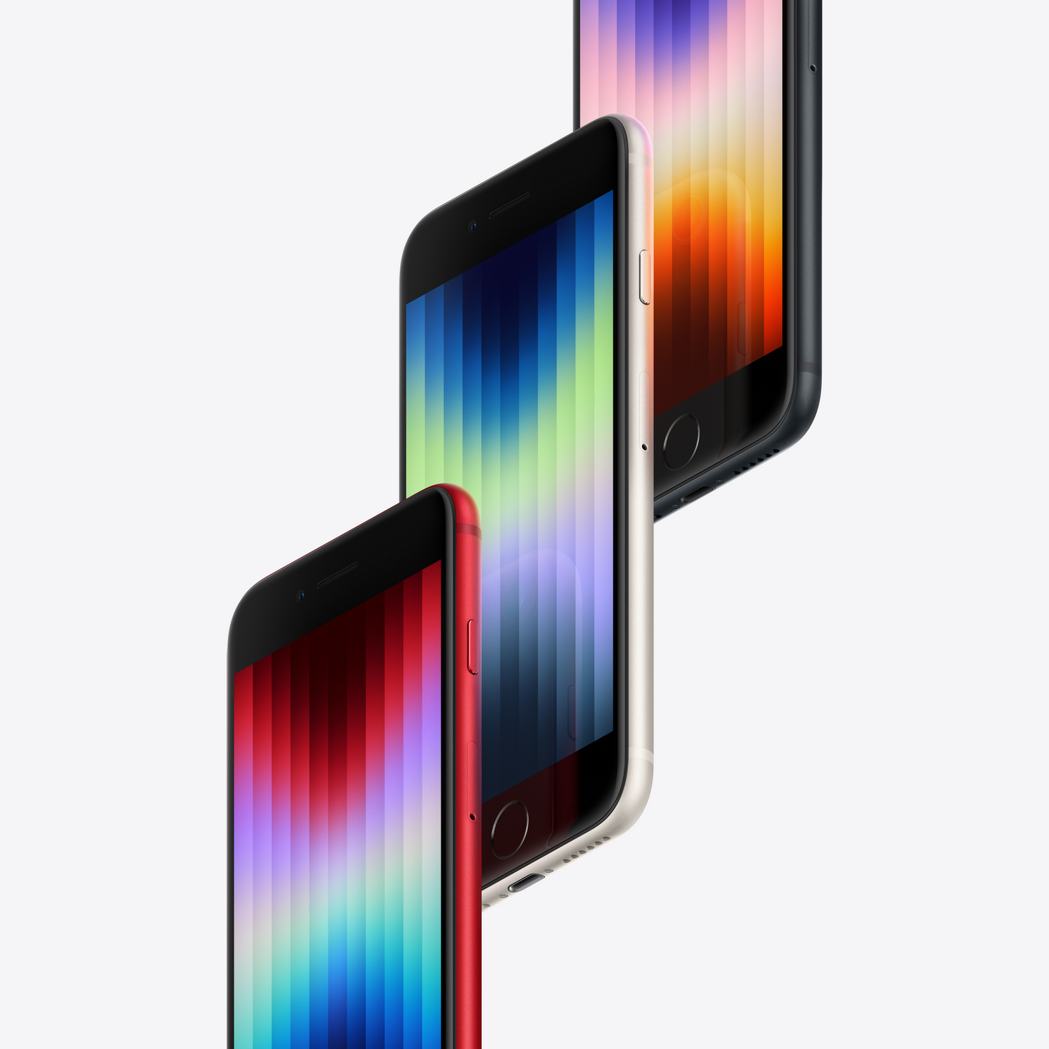 Tres iPhone SE de colores. Rojo, negro y blanquecino, dispuestos diagonalmente. Fondo blanco.