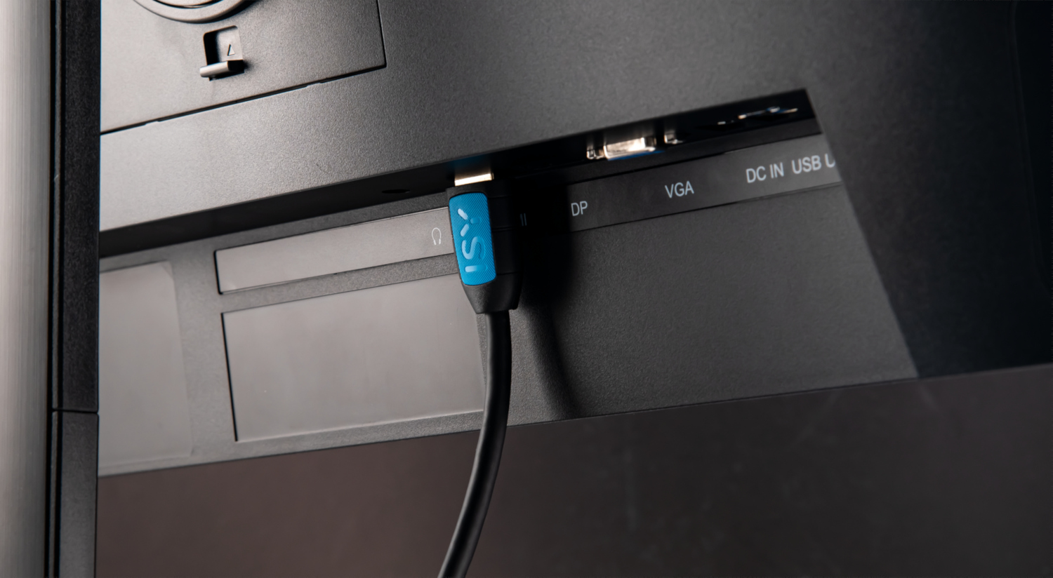A black monitor with a blue and black cable plugged into the back.