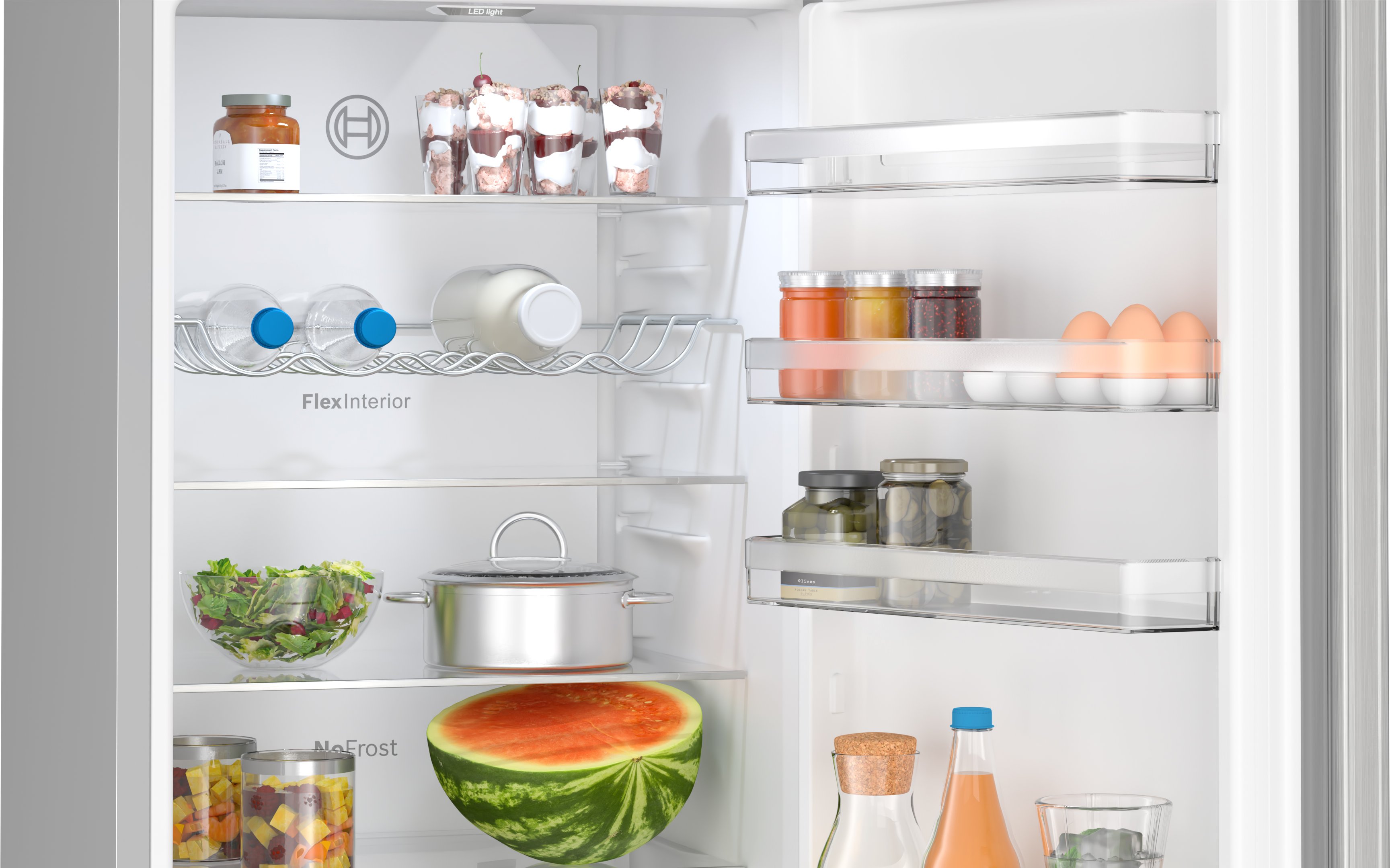 Offener Kühlschrank mit Lebensmitteln. Enthält Wasserflaschen, Gläser, Salat, Wassermelone und mehr.