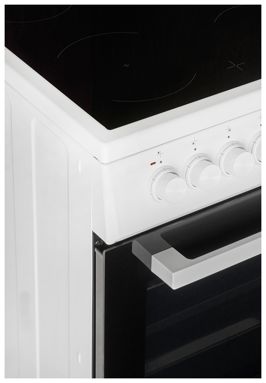 A white stove, with a black cooktop and oven door. Control knobs are visible on the front.