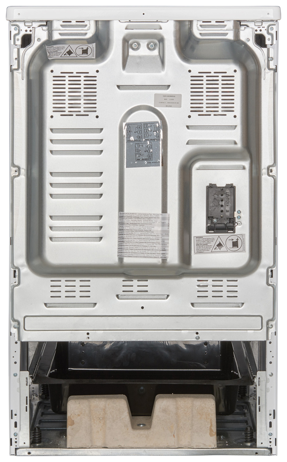 Back of a white oven, showing internal components and labels, with a black tray at the bottom.