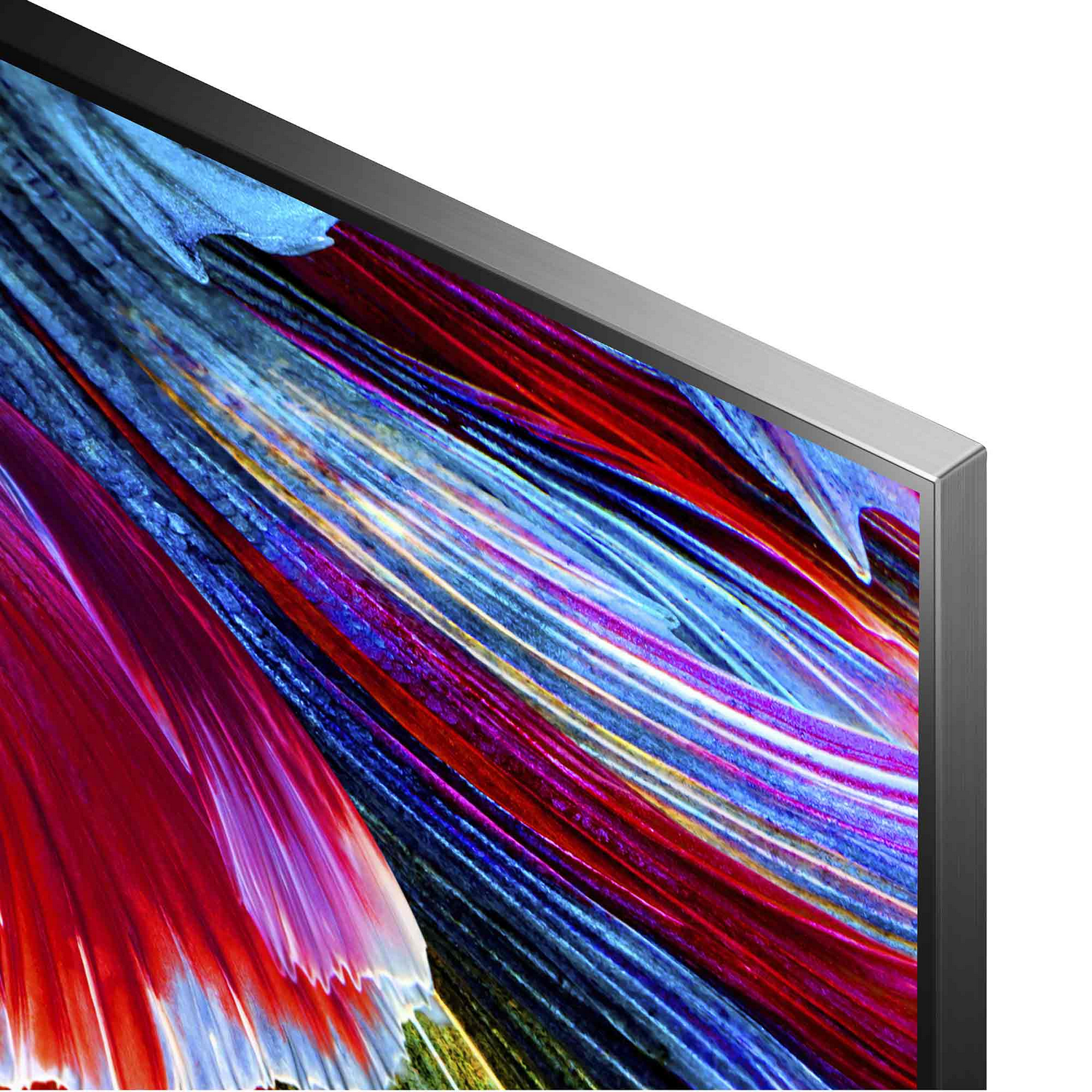 Primer plano del televisor. El marco es plateado, con una pantalla de patrones abstractos coloridos.
