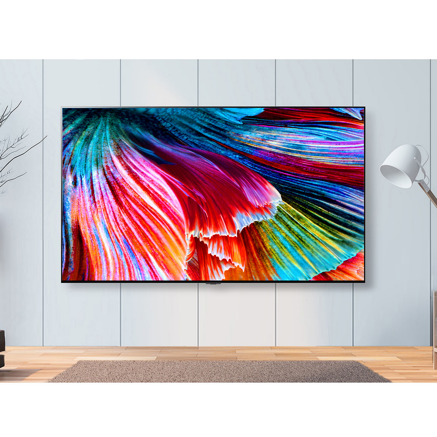 Diseño abstracto colorido en la pantalla de un televisor, montado en una pared blanca.