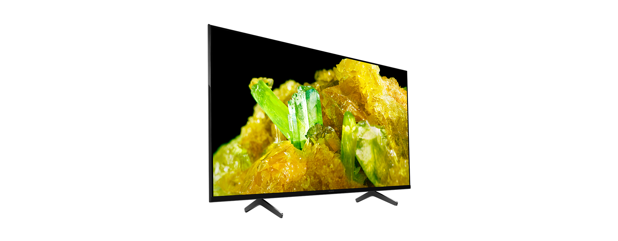 Ein Flachbildfernseher mit gelben und grünen Kristallen auf schwarzem Hintergrund.