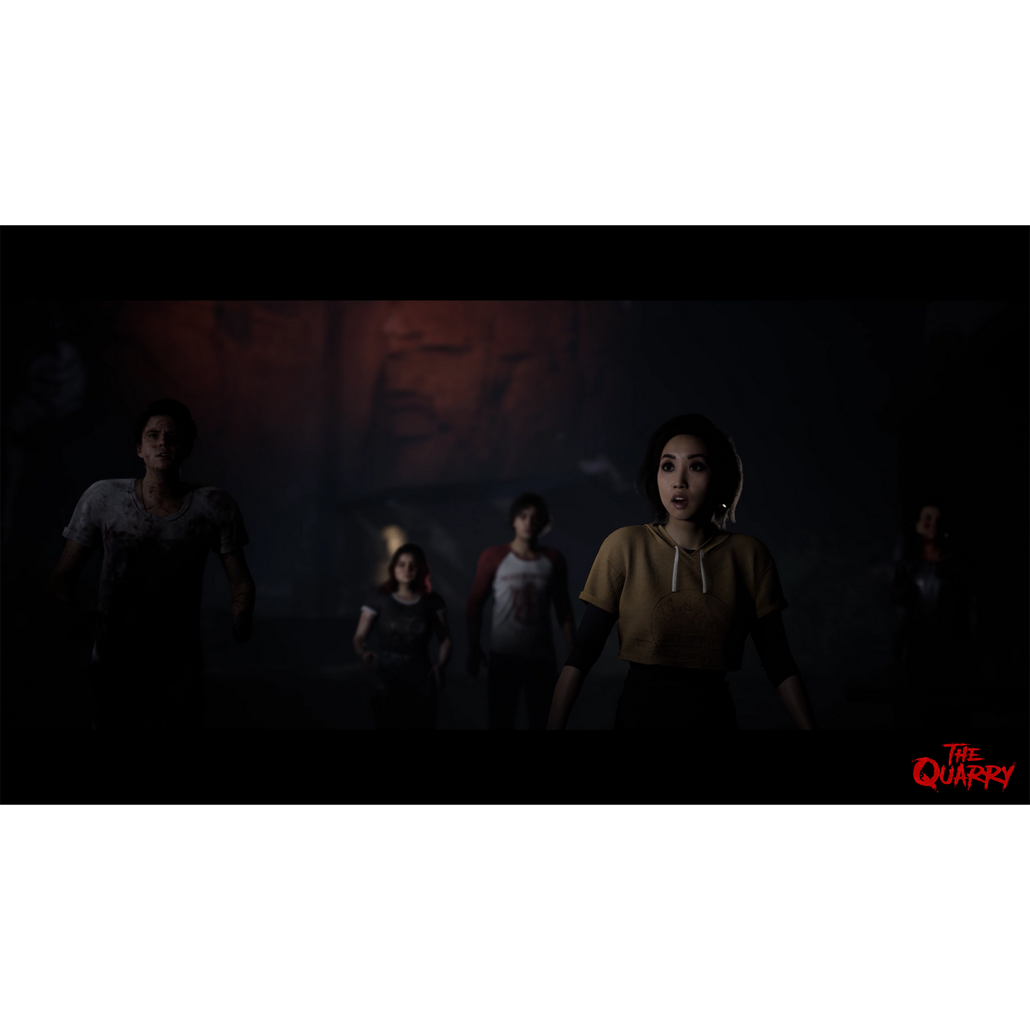 Un grupo de personas están en un pasillo oscuro mirando hacia arriba. El logo de "The Quarry" está en la parte inferior derecha.