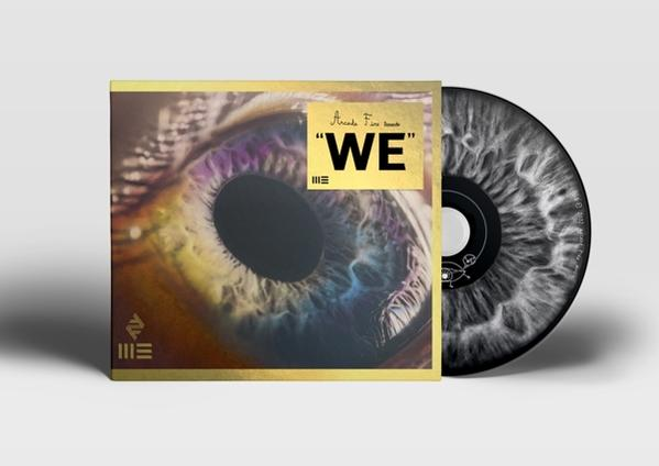 Album cover with an eye image and the words "WE" in gold. Black CD on the right side.