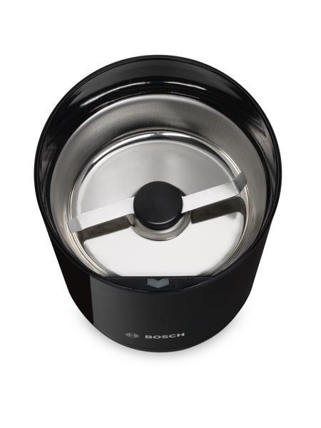 Eine schwarze Kaffeemühle, Draufsicht, mit silbernem Innenraum und kreuzförmiger Klinge.