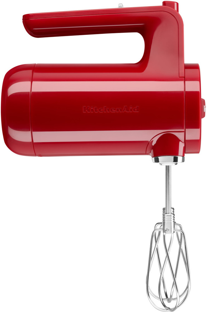 Red KitchenAid hand mixer with a whisk attachment, isolated on white background.
