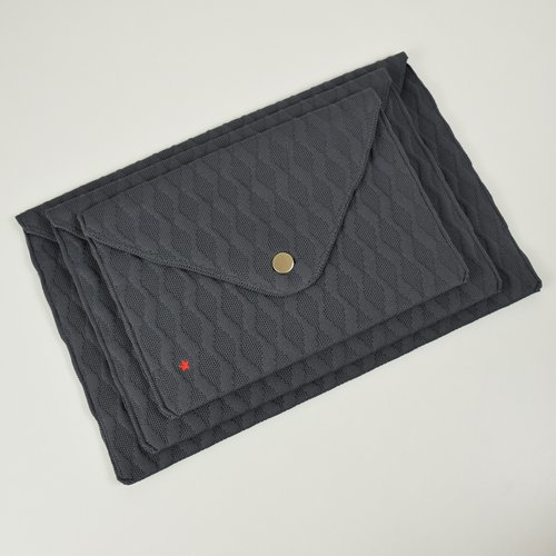 Three gray fabric cases with a red star. One case is open.
