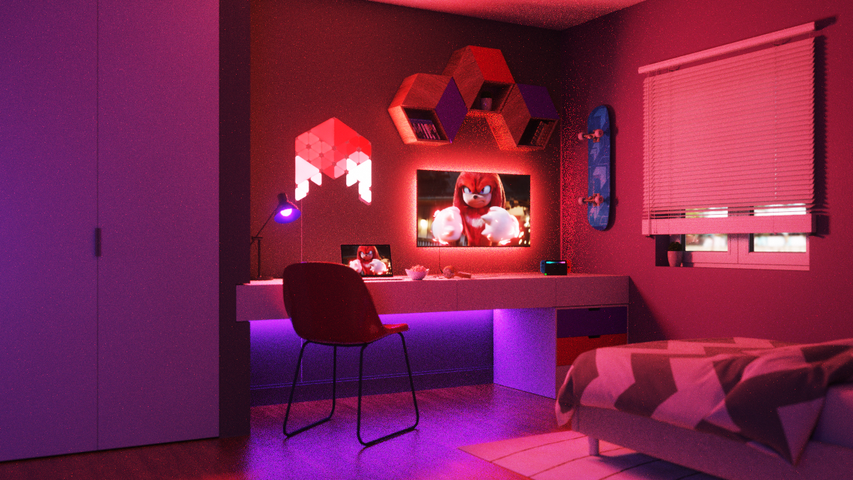Schlafzimmer mit roter und violetter Beleuchtung. Der Fernseher zeigt Sonic. Schreibtisch, Stuhl und Bett sind sichtbar.
