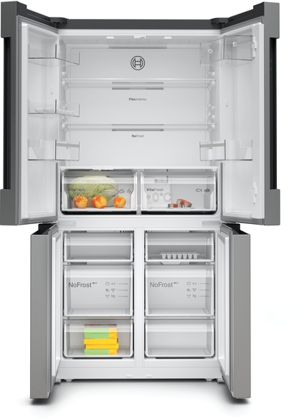 An open stainless steel refrigerator with food in the crisper drawers. It has a Bosch logo.