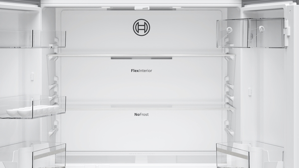 An empty refrigerator interior with glass shelves, the Bosch logo is visible.