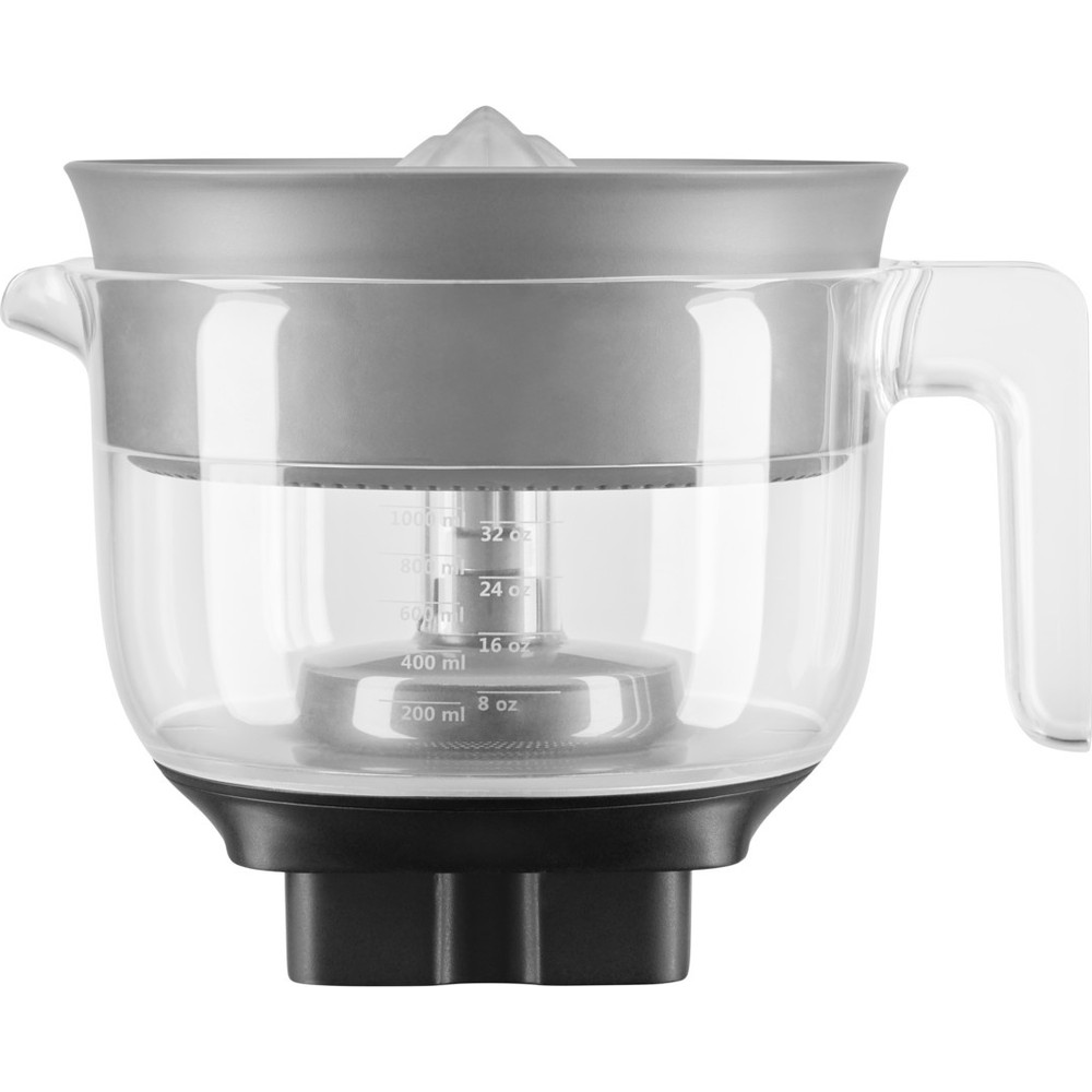 Clear juicer with a measuring scale, gray lid, and black base, handle visible.