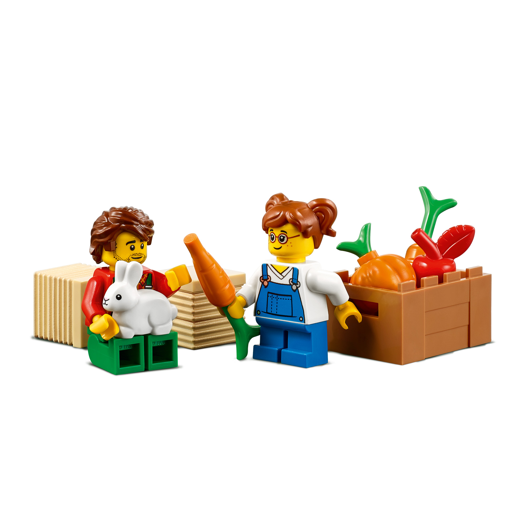 Lego-Figuren, ein Mann mit einem Hasen und eine Frau mit einer Karotte, neben einer Kiste mit Gemüse.