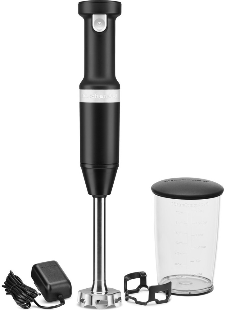 Black KitchenAid immersion blender, with accessories: charger, holder, and measuring cup.