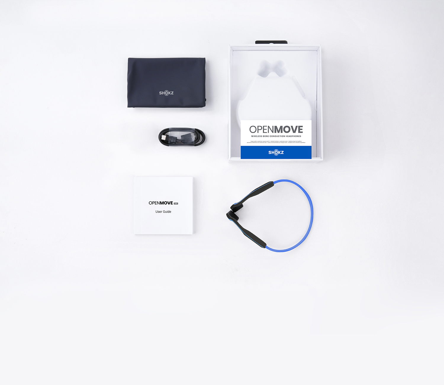 OpenMove headphones and accessories. The package, charging cable, user guide, and pouch are visible.