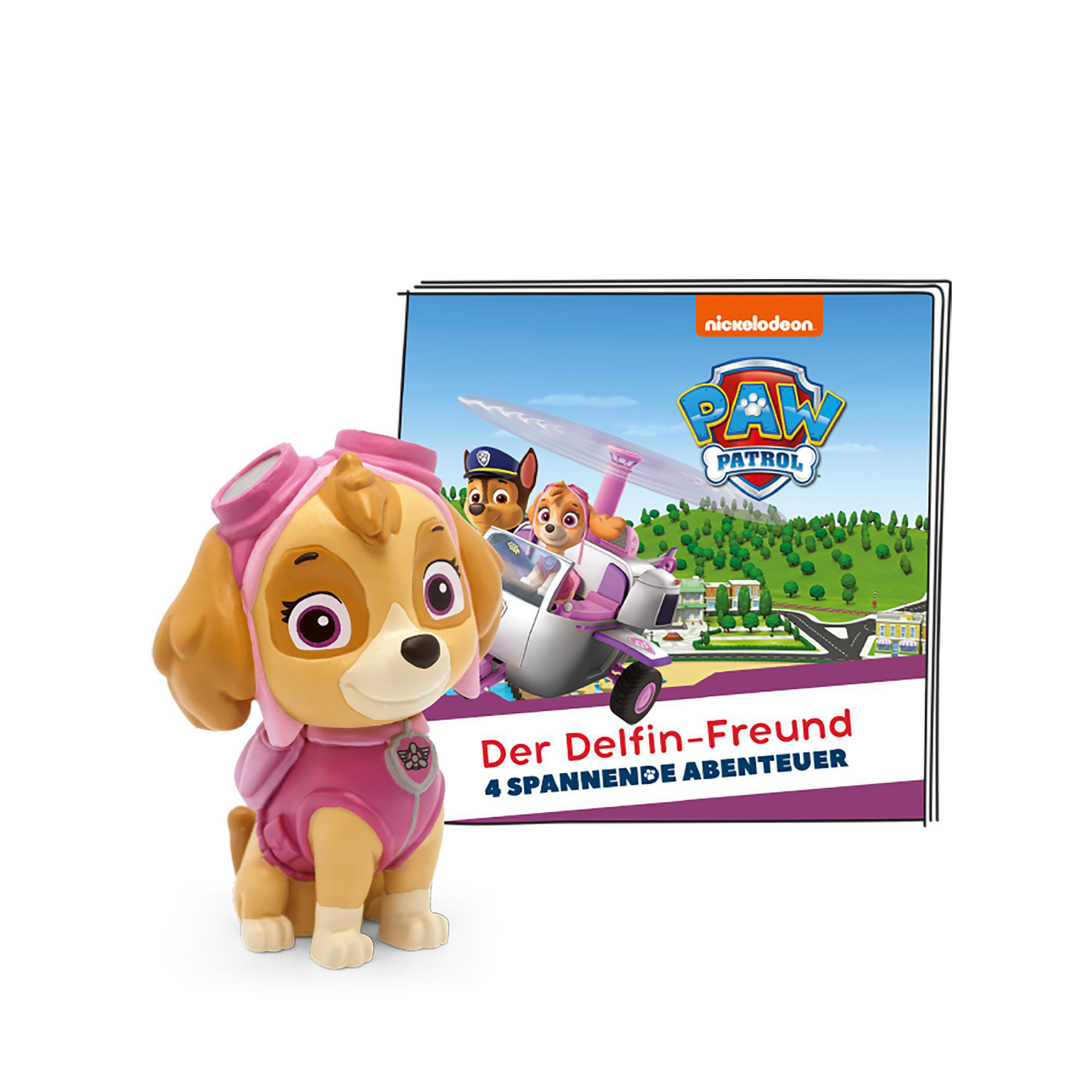 Eine Skye-Figur mit einem Buch über Delfine. Das Buch hat das Paw Patrol-Logo.