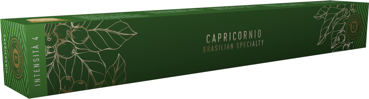 Green box of Capricornio coffee beans. It has gold leaf illustrations and text on it.