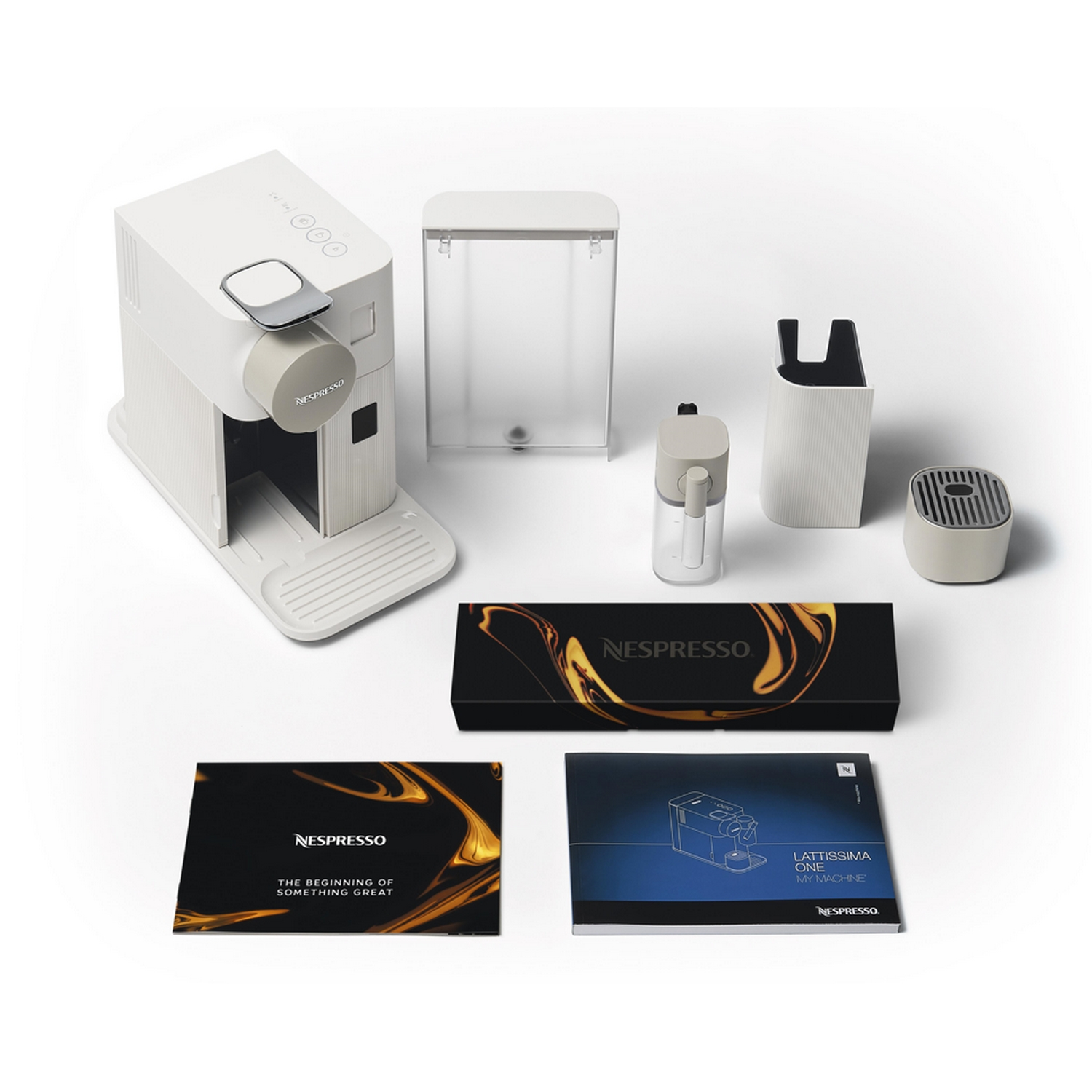 Piezas de cafetera: máquina blanca, contenedor de agua, contenedor de leche e instrucciones.